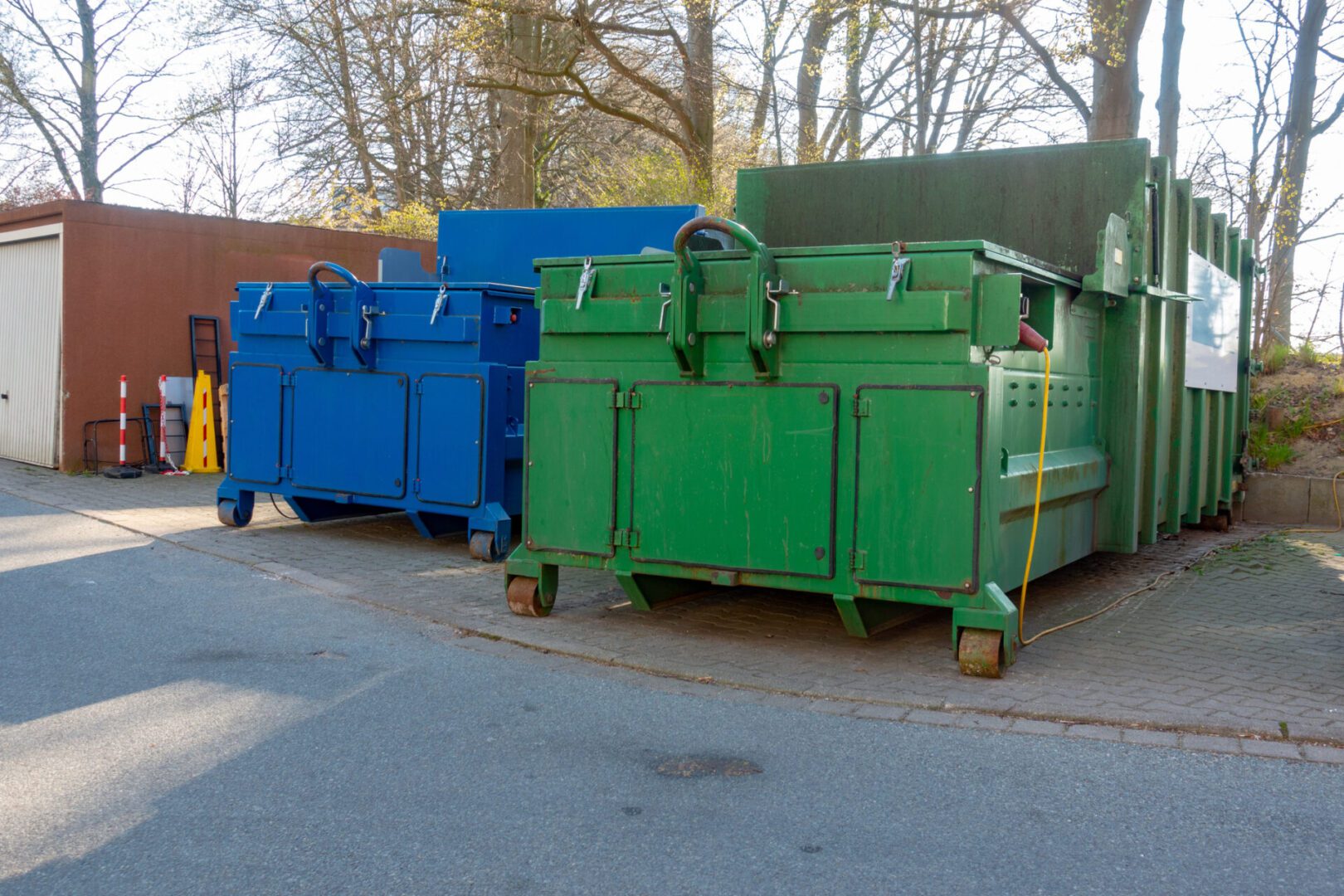 Business waste management container beside a Houston retail property.