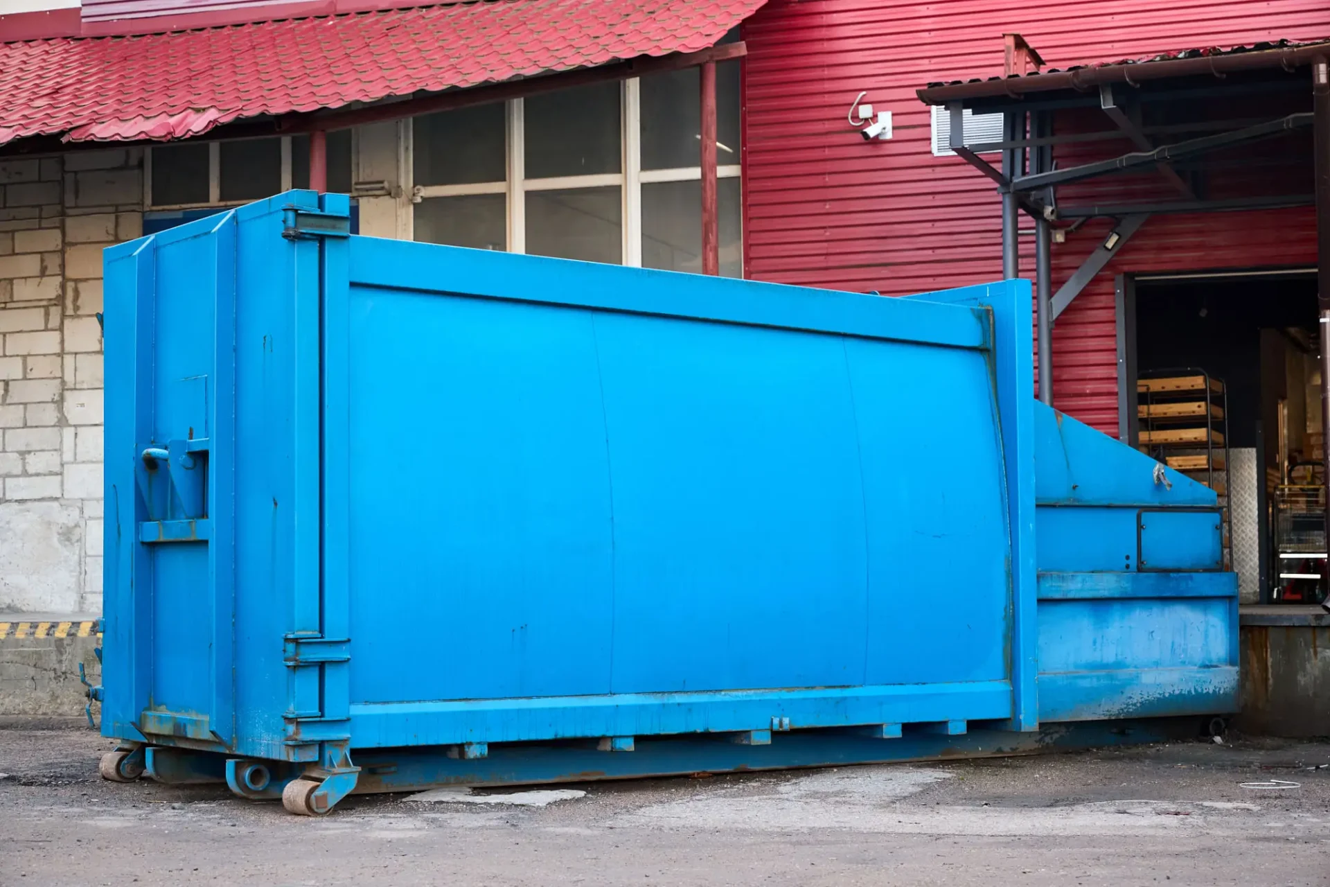 Workers removing bulky debris during comprehensive warehouse cleanout services.